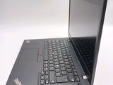 a black laptop with a red button on the keyboard