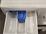 a white washer and dryer with a blue lid