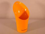 an orange cup that is sitting on a table