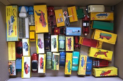 a cardboard box filled with assorted toy cars and trucks
