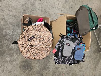 a box full of luggage and a backpack sitting on the floor
