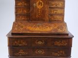 an old wooden bureau with drawers and drawers on wheels