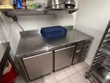 a kitchen with a stainless steel counter top and shelves