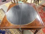 a table that has a black leather top on it