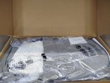 a box with some white shirts inside of it