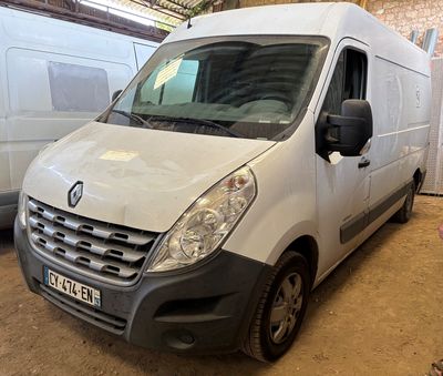 a man standing next to a white van in a garage