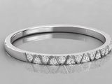a white gold wedding band with diamonds on a reflective surface