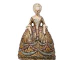 an image of a figurine of a woman in a dress