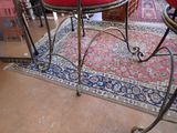 a red chair sitting on a rug in a room