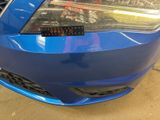 a close up of a blue car with a sticker on it