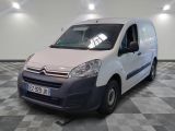 a white van parked in a room with checkered flooring