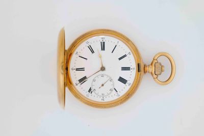 a gold pocket watch with roman numerals on it
