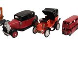 several toy cars are lined up in a row on a white surface