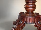 a wooden table with a wooden top and a wooden base