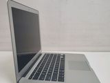 a silver laptop computer sitting on a white table