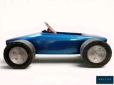 a blue toy car that is sitting on a white surface