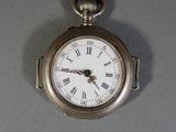 a silver pocket watch with roman numerals on the face