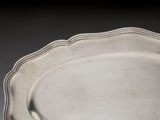 a white plate with a decorative edge on a table