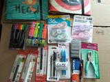 a cardboard box filled with school supplies and pens