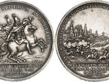 an image of a silver coin with a picture of a man on a horse