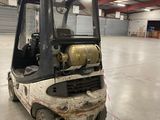 a fork truck that is parked in a warehouse