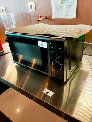 a microwave sitting on top of a table in a kitchen