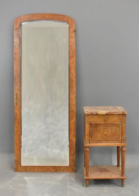 an image of a mirror and a small table in front of a gray wall