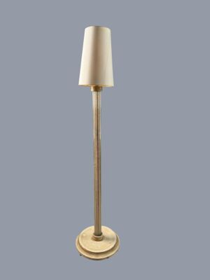 the floor lamp has a white shade on top of it