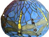 a close up of a lamp shade with dragonflies on it