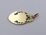 a close up of a gold pendant with a fish on it