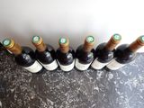 several bottles of wine are lined up in a row on a table
