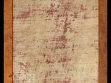 an old picture of a wooden frame with a red stain on it