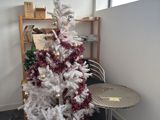 a white christmas tree in the corner of a room