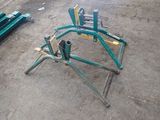 a broken chair sitting on the ground in the dirt