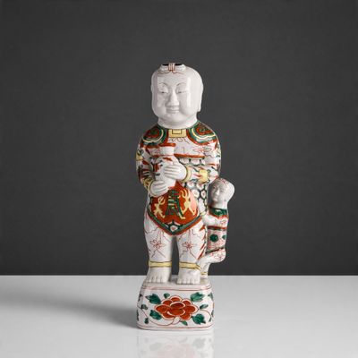 a close up of a statue of a person holding a flower