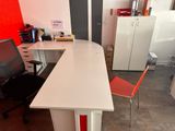 a desk with a chair and a computer on it