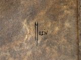 a close up of a brown book with writing on it