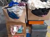 a pile of clothes on top of a carton on the street