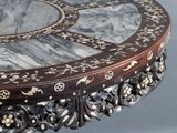a round table with a marble top and a wooden base