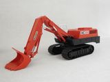 a toy excavator that is sitting on a white surface