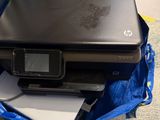 laptop and printer sitting in a blue bag on the floor