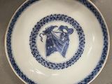 a blue and white plate with a picture of a dragon on it