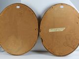pair of wooden drums with labels on them sitting on a white surface