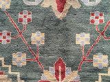 a close up of a blue rug with a red and yellow design