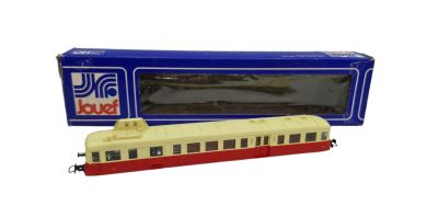 the train is red and white with a red stripe