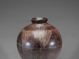 an image of a vase on a stand on a gray background