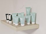 a shelf that has many different types of skin care products on it