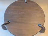 a wooden plate with metal handles on a white table