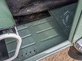 a close up of a green car door with an umbrella on it