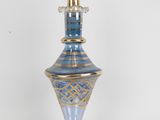 a blue and gold vase on a white table
